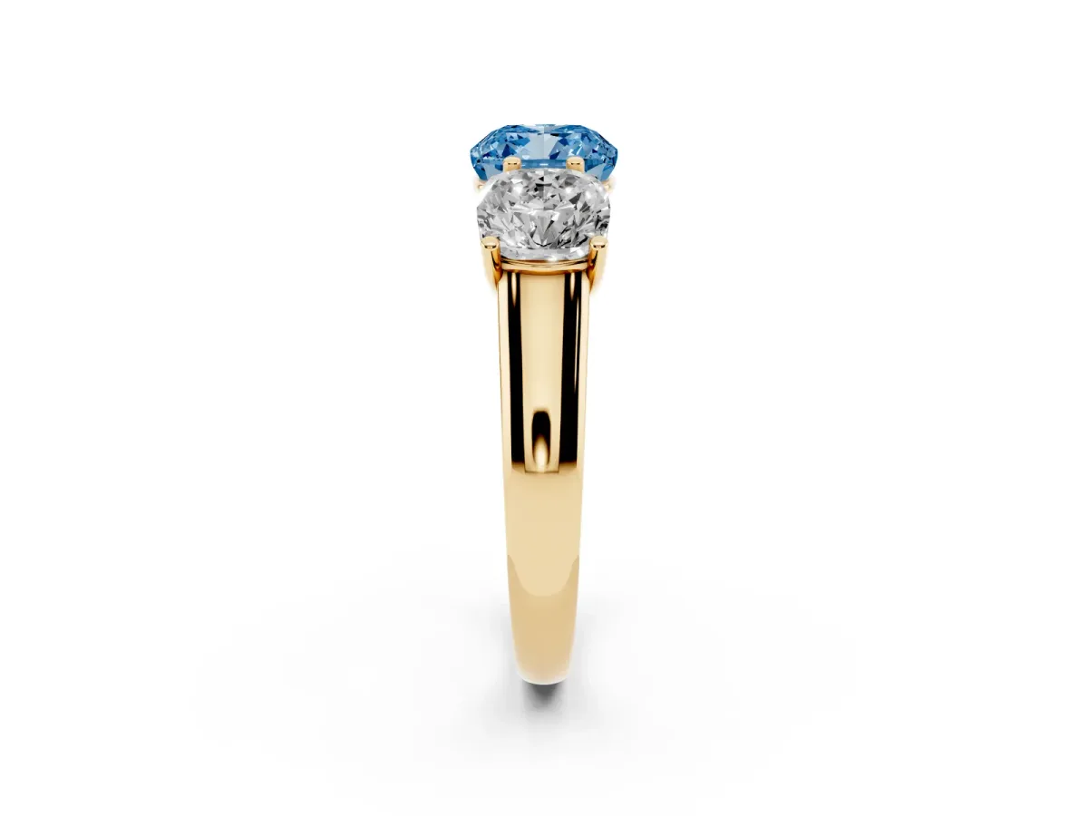Fancy Blue Cushion Cut Three-Stone Diamond Ring with Prong Setting on a Classic Band Yellow gold