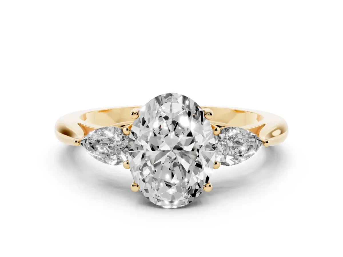 Three-Stone Oval Cut Diamond Ring with Pear Side Stones in Four-Prong Setting Yellow gold