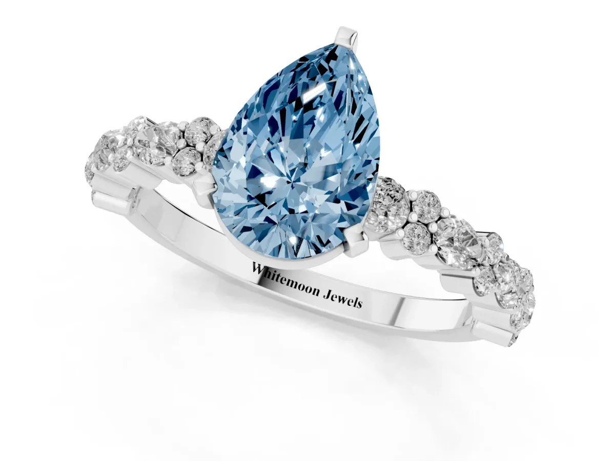Fancy Blue Pear Cut Diamond Side Stone Solitaire Ring with Round and Four-Prong Setting White gold