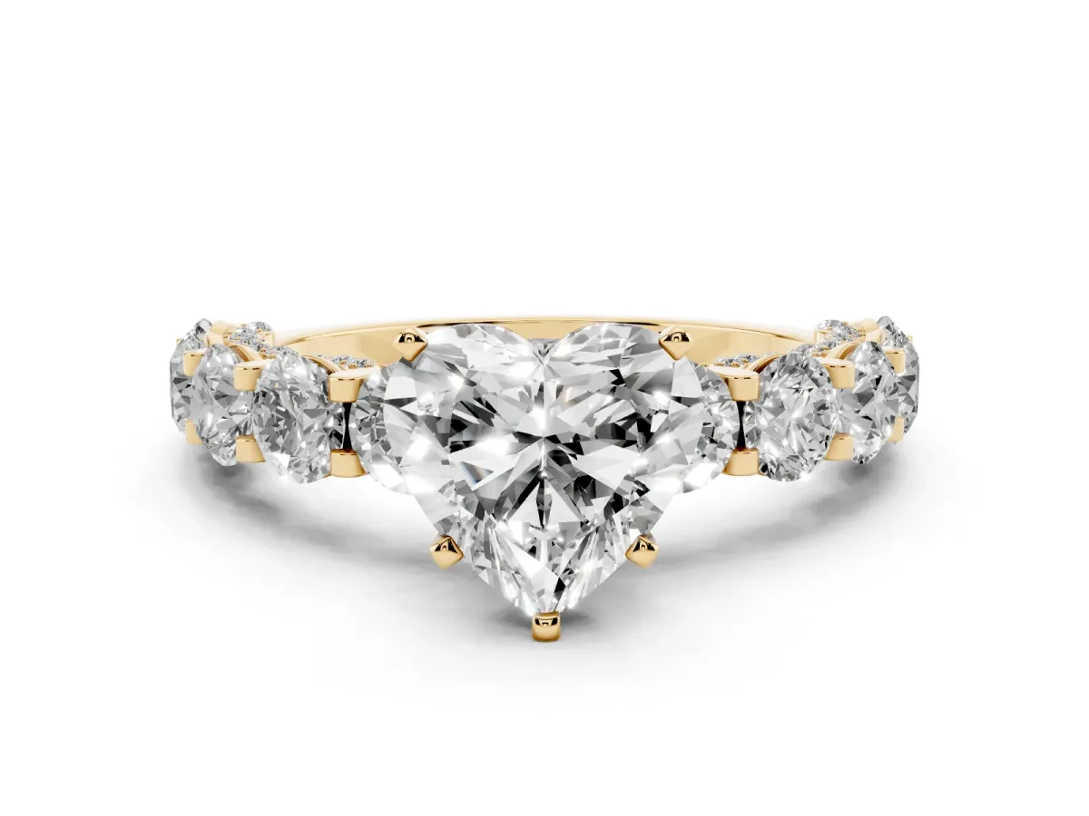 Heart Cut Diamond Side Stone Engagement Ring with Four-Prong Setting Yellow gold
