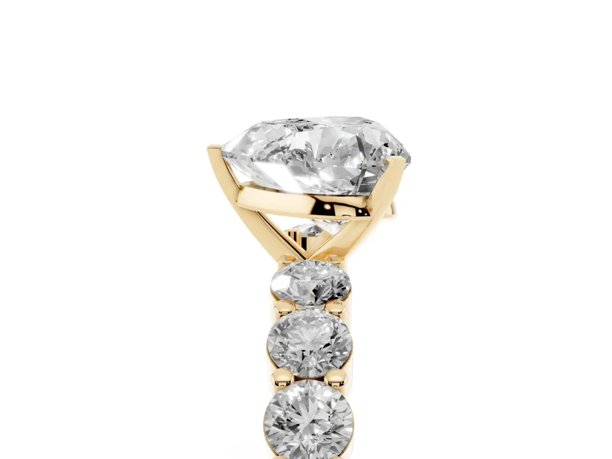 Heart Cut Diamond Solitaire Ring with Shared Prong Round Side Stones Yellow gold