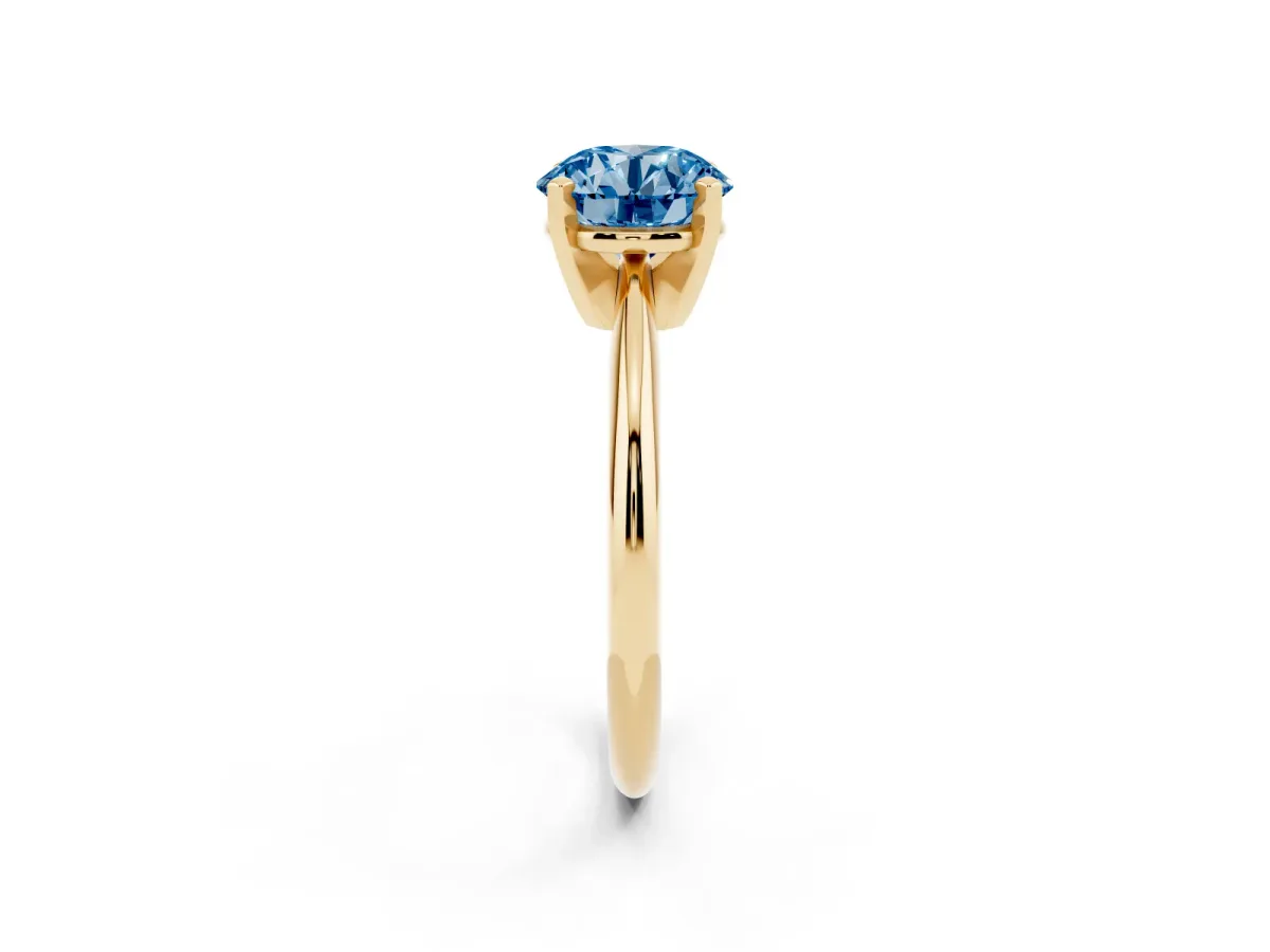 Fancy Blue Round Cut Cut Solitaire Ring with Four-Prong Setting on a Classic Band Yellow gold