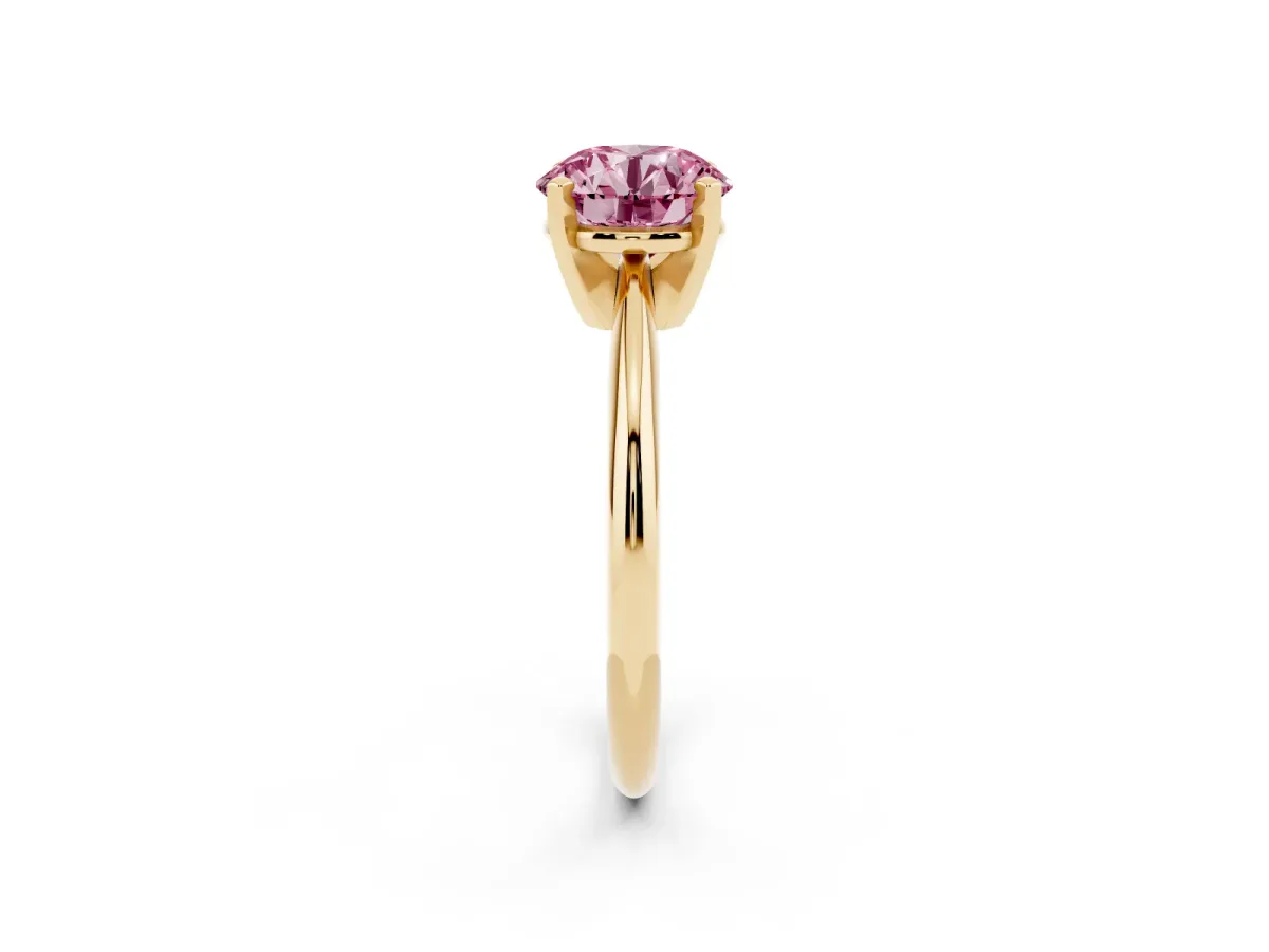 Fancy Pink Round Cut Cut Solitaire Ring with Four-Prong Setting on a Classic Band Yellow gold