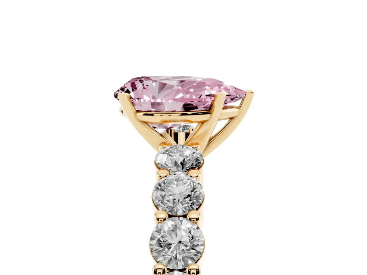 Fancy Pink Pear Cut Diamond Solitaire Ring with Shared Prong Round Side Stones Yellow gold