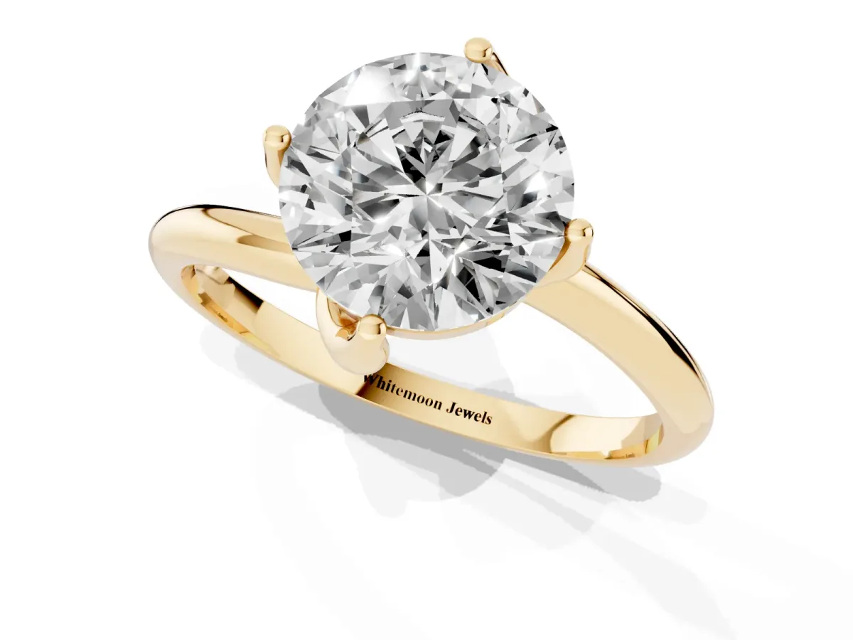 Round Cut Diamond Solitaire Engagement Ring with Four-Prong Setting and Classic Band Yellow gold
