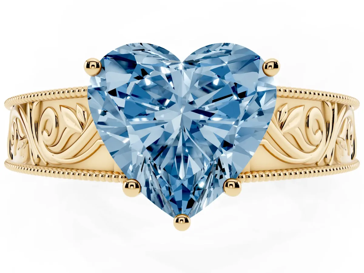 Fancy Blue Heart Cut Diamond Solitaire Ring with Engraved Band and Four-Prong Setting Yellow gold