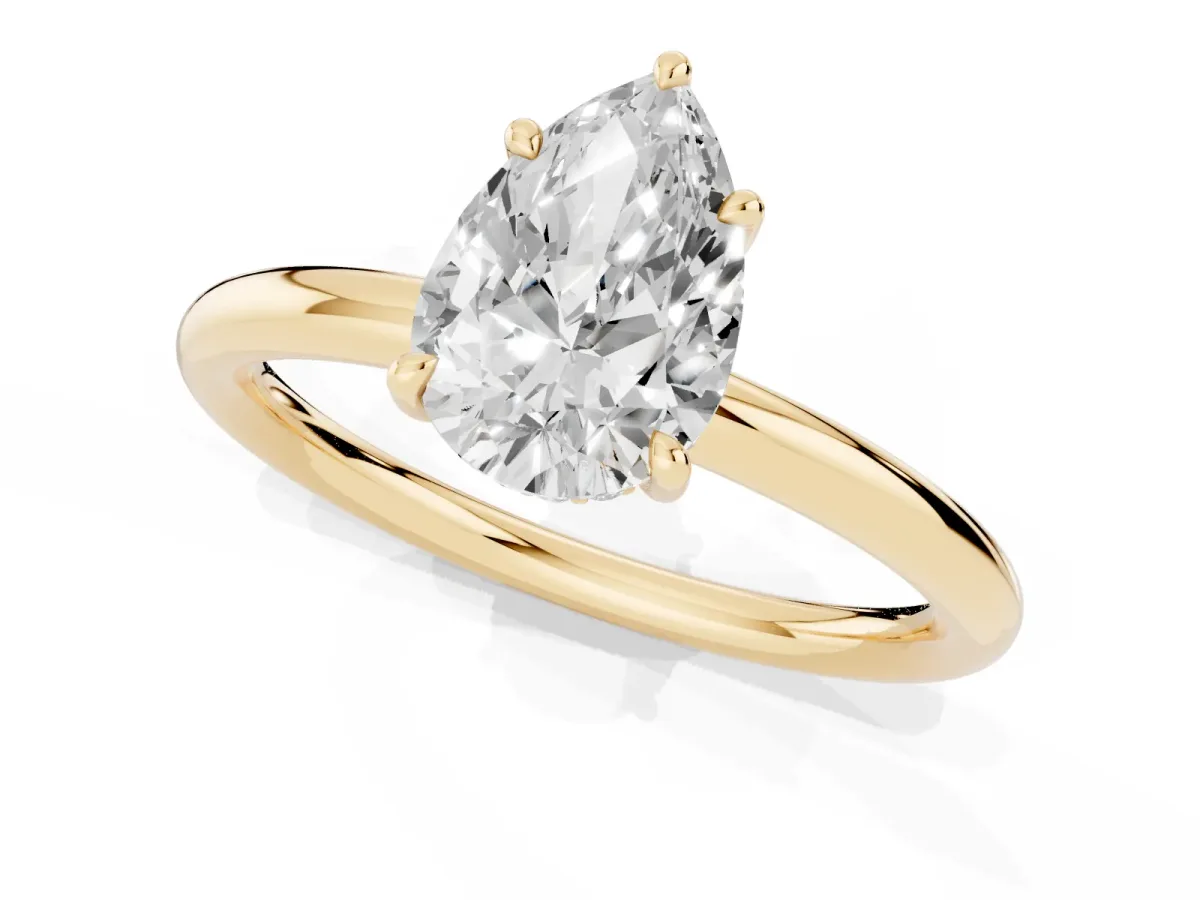 Pear Cut Diamond Solitaire Ring with Thin Band and Four-Prong Setting Yellow gold