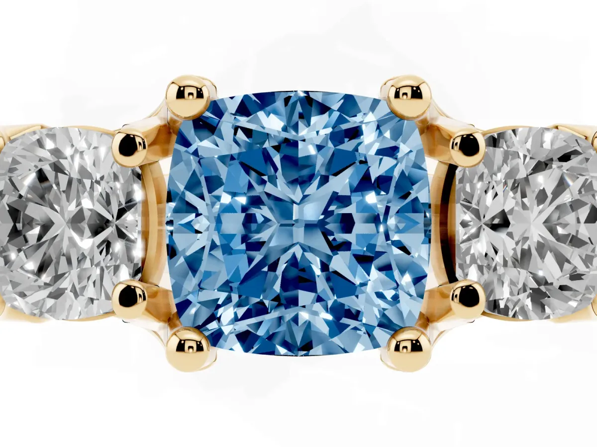 Fancy Blue Cushion Cut Diamond Three-Stone Ring with Channel Set Band and Four-Prong Setting Yellow gold