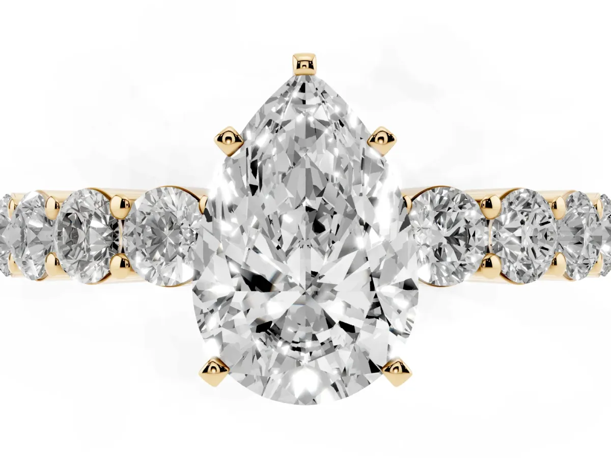 Pear Cut Diamond Solitaire Ring with Shared Prong Round Side Stones Yellow gold