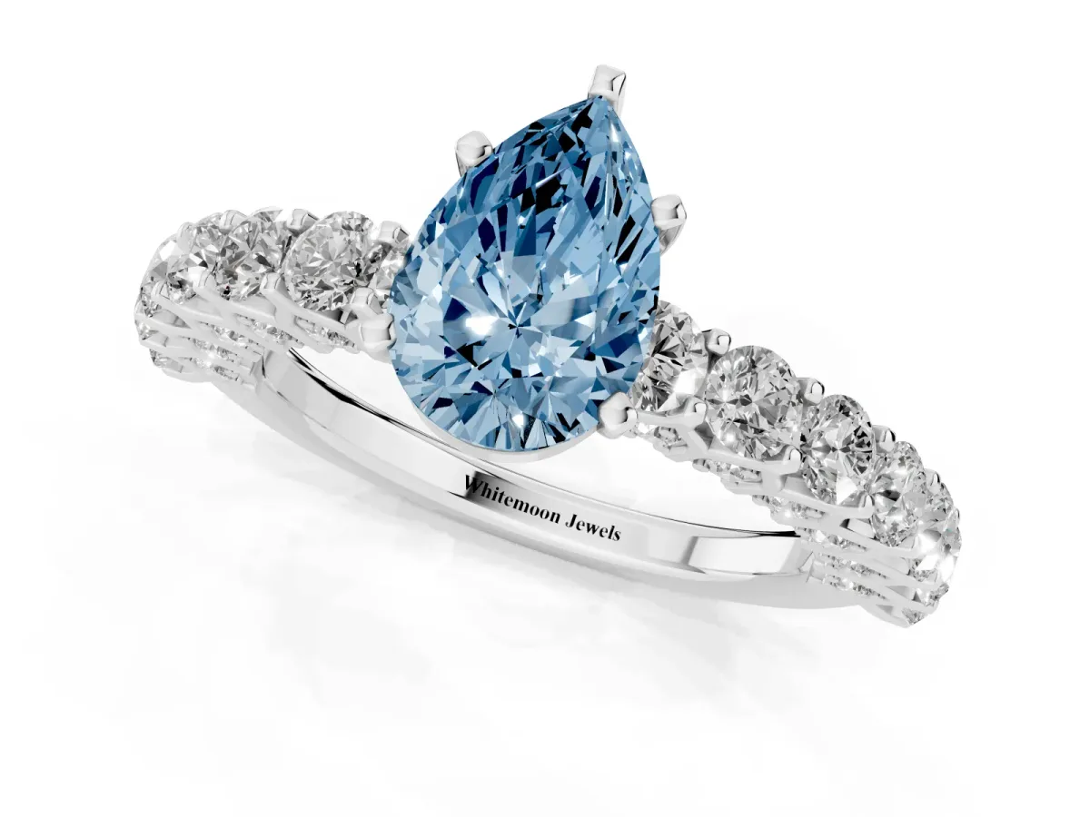 Fancy Blue Pear Cut Diamond Solitaire Ring with Shared Prong Pavé Band and Four-Prong Setting Silver