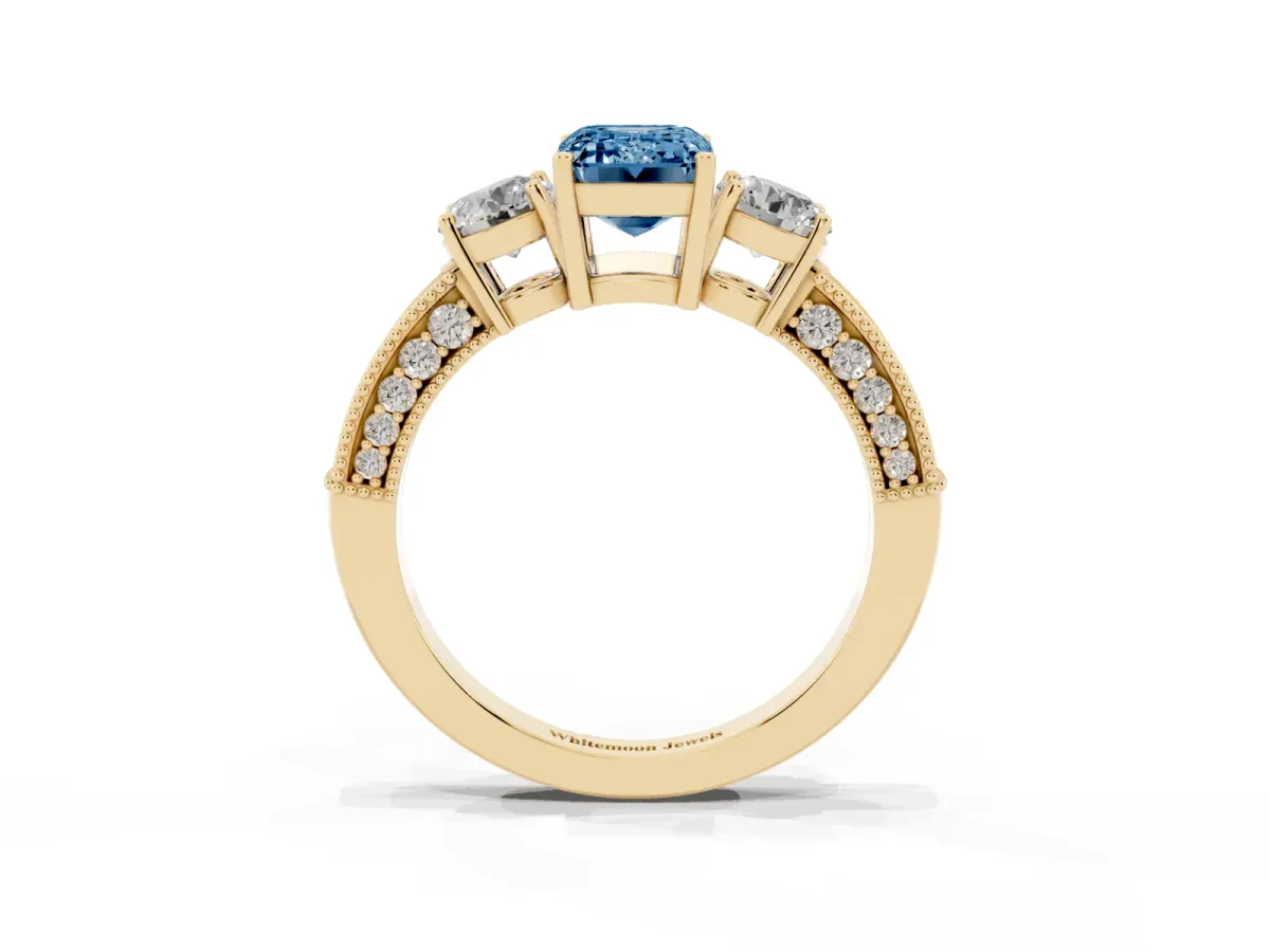 Fancy Blue Emerald Cut Three-Stone Diamond Ring with Pavé Band and Four-Prong Setting Yellow gold