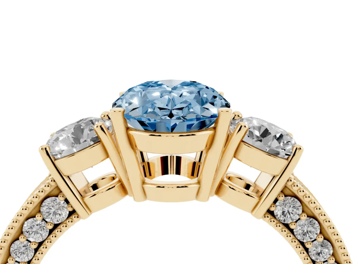 Fancy Blue Oval Cut Three-Stone Diamond Ring with Pavé Band and Four-Prong Setting Yellow gold