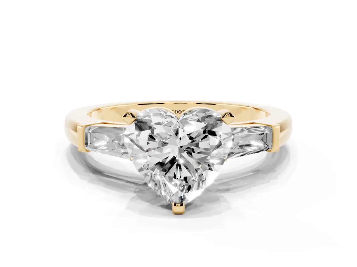 Heart Cut Solitaire with Tapered Baguette Side Stones on a Classic Band with Four-Prong Setting Yellow gold