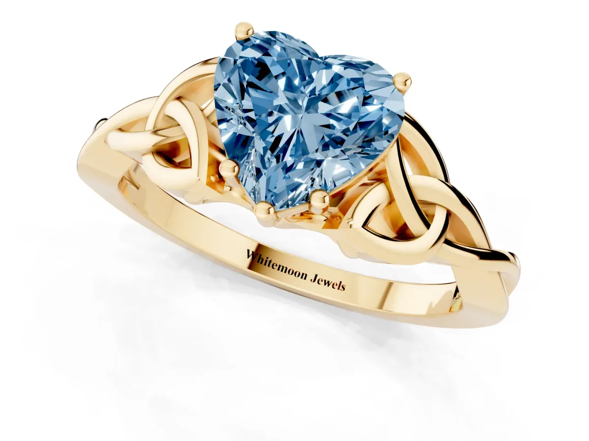 Fancy Blue Heart Cut Diamond Solitaire Engagement Ring with Celtic Knot Band and Four-Prong Setting Yellow gold