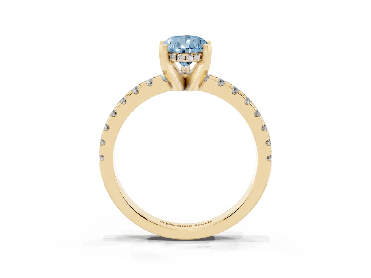 Fancy Blue Pear Cut Diamond Solitaire Ring with Round Pavé Band and Four-Prong Setting Yellow gold