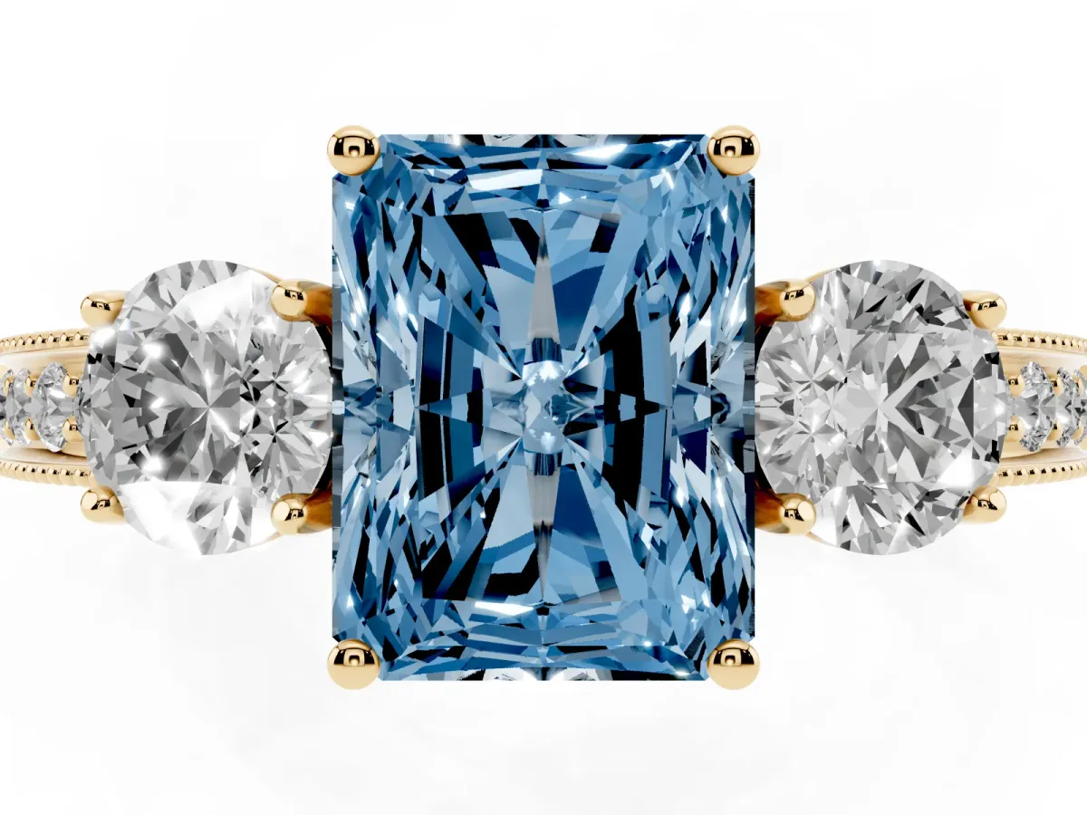 Fancy Blue Radiant Cut Three-Stone Diamond Ring with Pavé Band and Four-Prong Setting Yellow gold