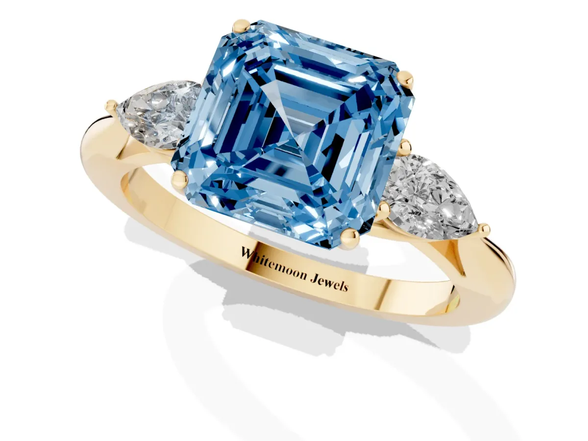 Fancy Blue Three-Stone Asscher Cut Brilliant Diamond Solitaire Ring with Tapered Band and Four-Prong Setting Yellow gold