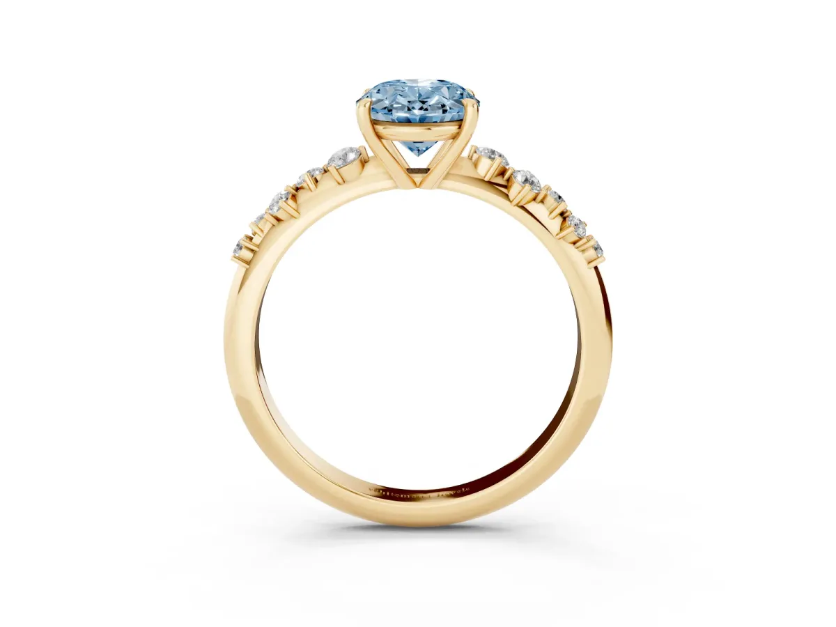 Fancy Blue Oval Cut Diamond Cluster Side Stone Solitaire Ring with Prong Setting Yellow gold