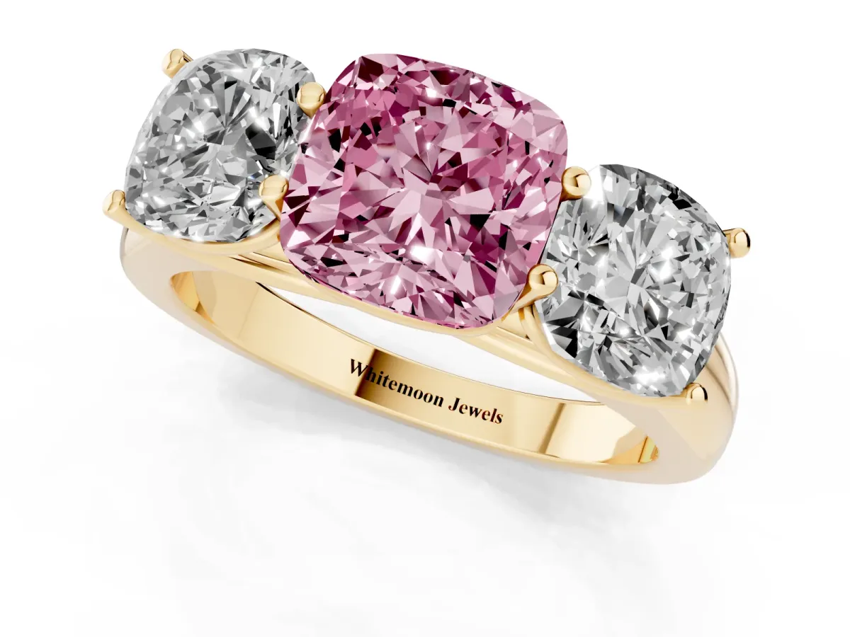 Fancy Pink Cushion Cut Three-Stone Diamond Ring with Prong Setting on a Classic Band Yellow gold