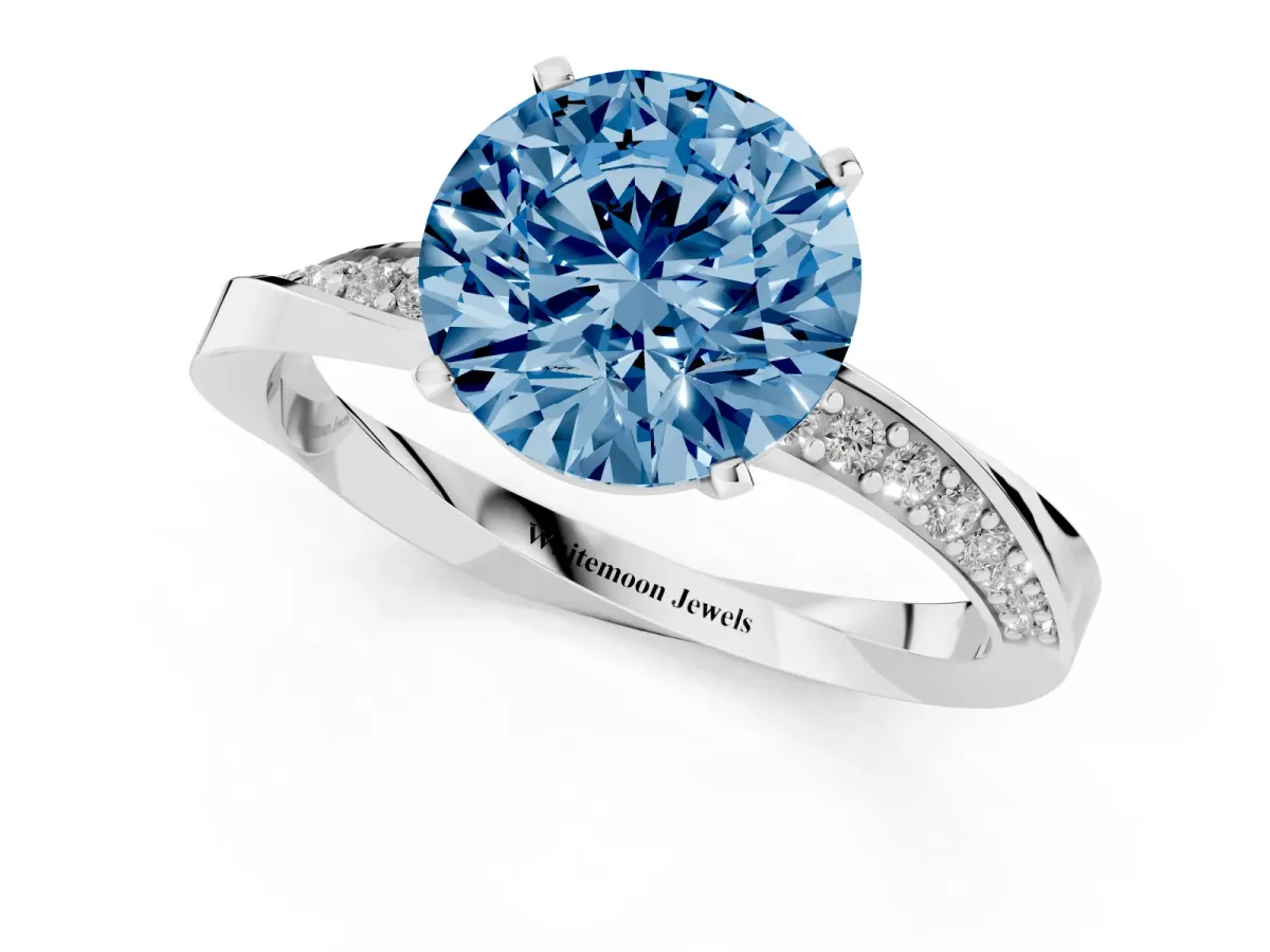 Fancy Blue Round Cut Diamond Engagement Ring with Side Stone Accents and Four-Prong Setting Silver