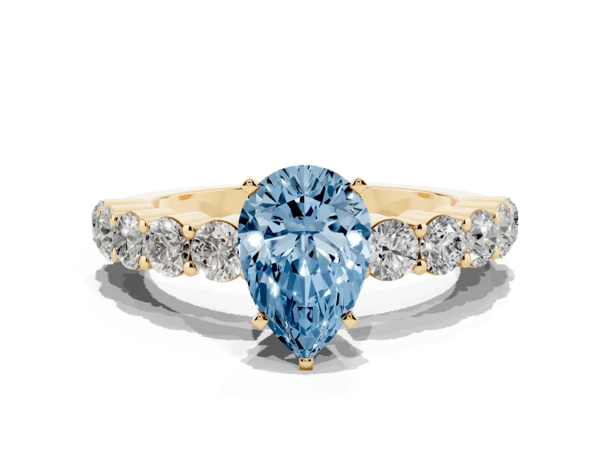 Fancy Blue Pear Cut Diamond Solitaire Ring with Shared Prong Round Side Stones Yellow gold