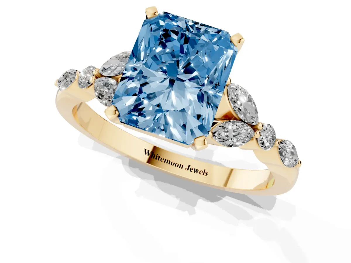 Fancy Blue Radiant Cut Diamond Solitaire Ring with Side Stones and Four-Prong Setting Yellow gold