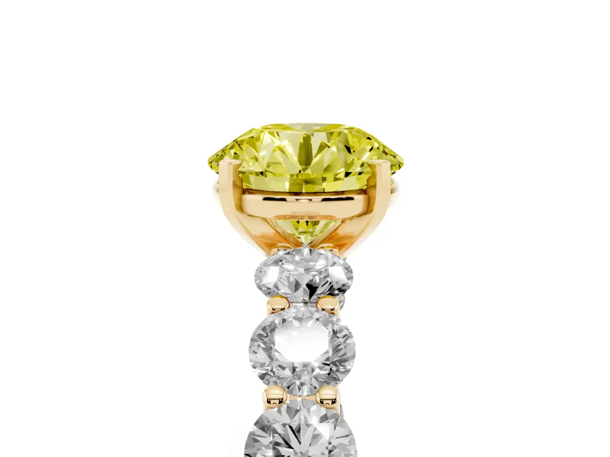 Fancy Yellow Round Cut Diamond Prong Setting with Side Stones on a Pave Band Yellow gold