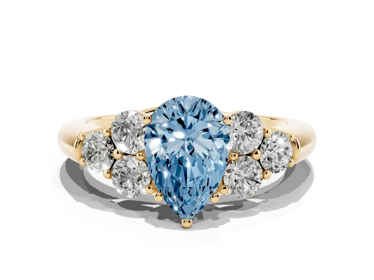 Fancy Blue Pear Cut Cut Diamond Cluster Ring with Round Accent Stones and Prong Setting on a Classic Band Yellow gold
