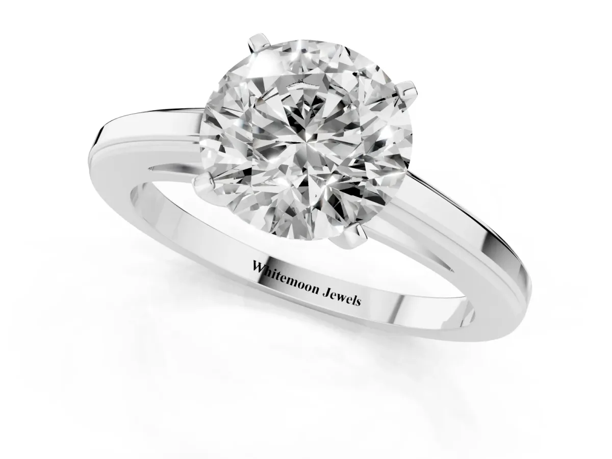 Round Cut Solitaire Diamond Ring with Four-Prong Setting and Classic Band Platinum