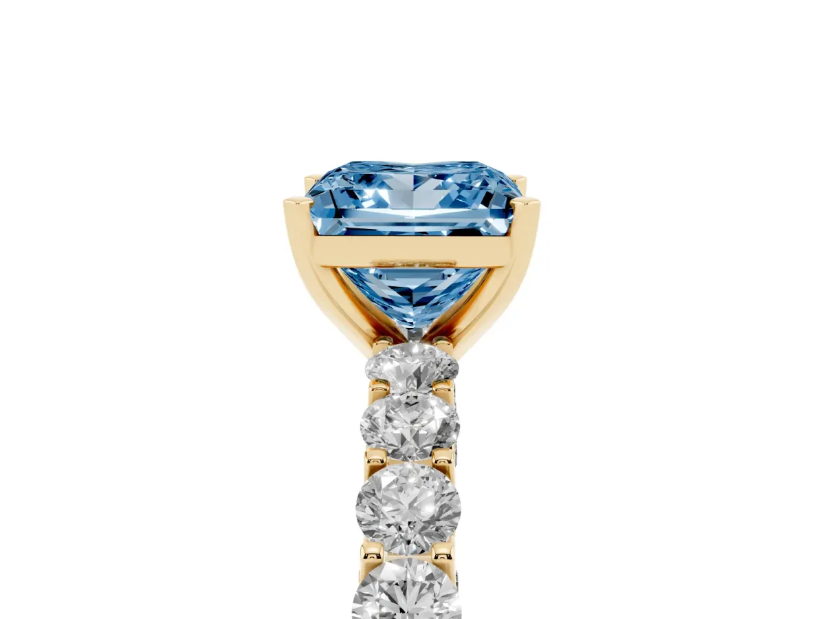Fancy Blue Princess Cut Diamond Solitaire Ring with Shared Prong Pavé Band and Four-Prong Setting Yellow gold