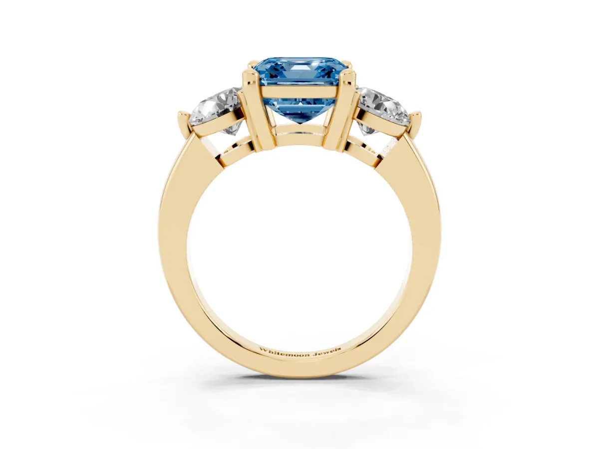 Fancy Blue Three-Stone Asscher Cut Brilliant Cut Solitaire Ring with Prong Setting on a Classic Band Yellow gold