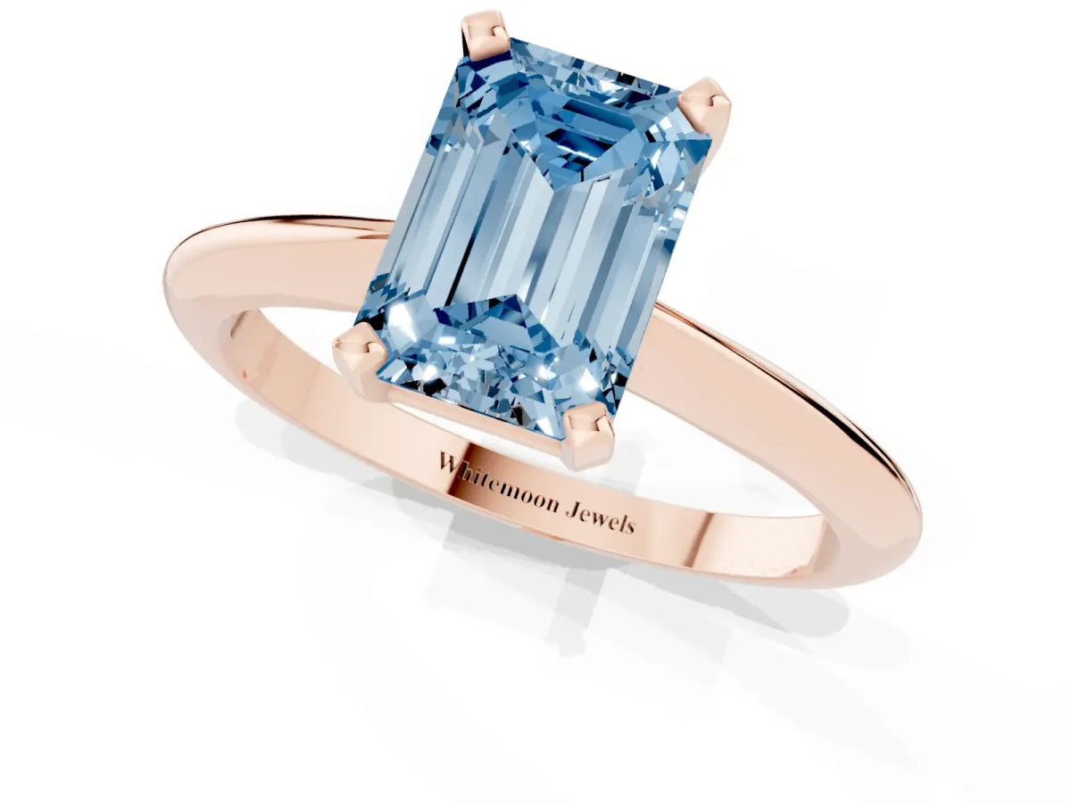 Fancy Blue Emerald Cut Cut Solitaire Ring with Four-Prong Setting on a Classic Band Rose gold