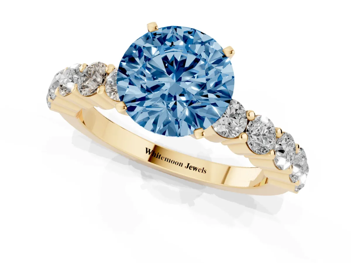 Fancy Blue Round Cut Diamond Solitaire Ring with Shared Prong Round Side Stones Yellow gold