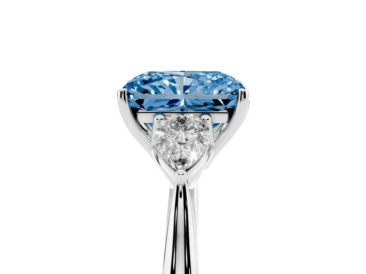 Fancy Blue Three-Stone Radiant Cut Diamond Ring with Pear Side Stones in Four-Prong Setting Platinum