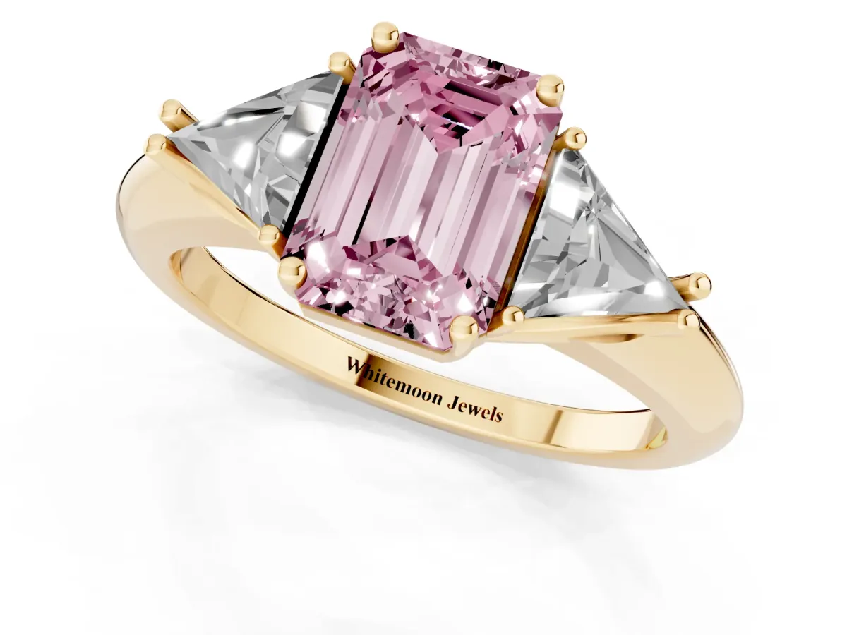 Fancy Pink Three-Stone Emerald Cut Diamond Engagement Ring with Trillion Side Stones and Prong Setting Yellow gold