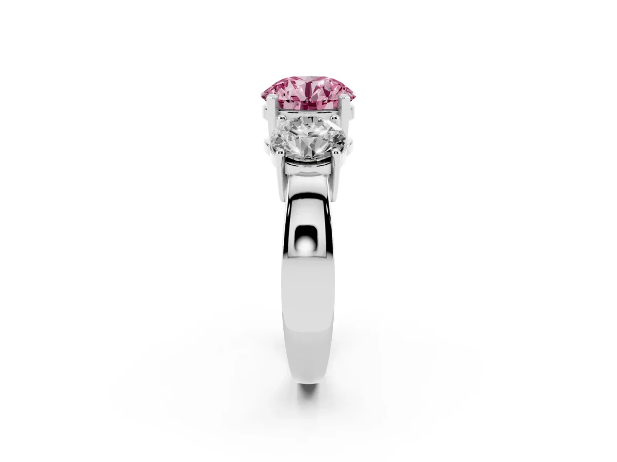 Fancy Pink Three-Stone Round Cut Diamond Ring with Round Side Stones, Classic Band, and Four-Prong Setting Platinum