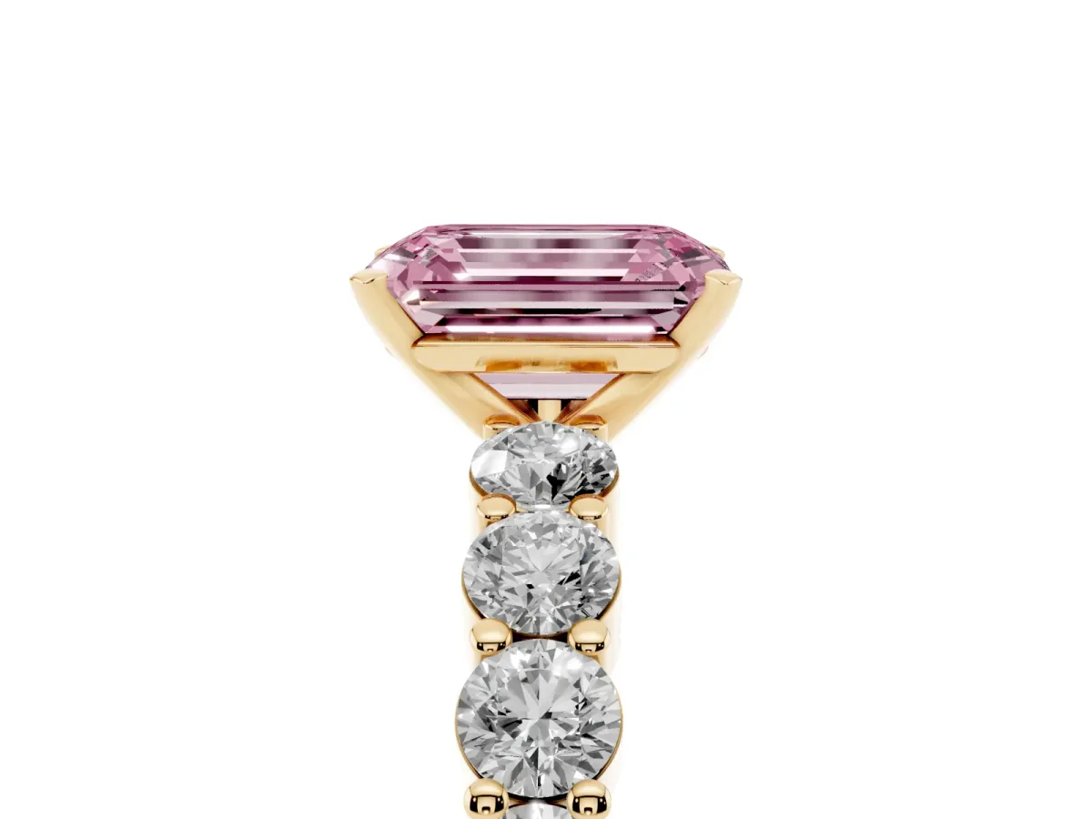 Fancy Pink Emerald Cut Diamond Solitaire Ring with Shared Prong Round Side Stones Yellow gold