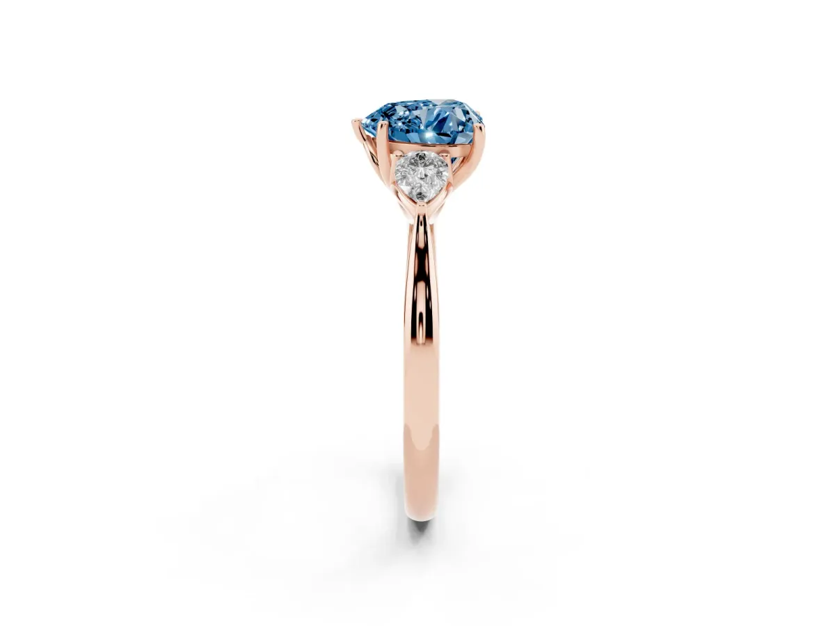 Fancy Blue Three-Stone Heart Cut Diamond Ring with Pear Side Stones in Four-Prong Setting Rose gold