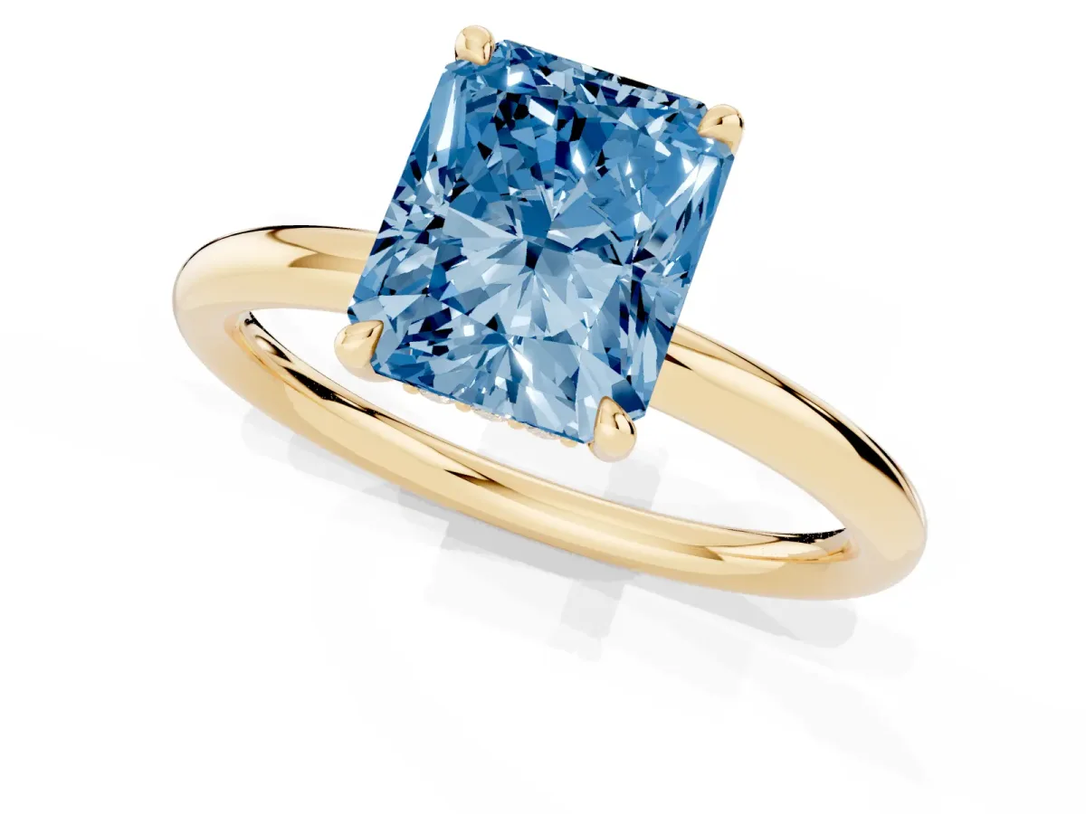 Fancy Blue Radiant Cut Diamond Solitaire Ring with Thin Band and Four-Prong Setting Yellow gold