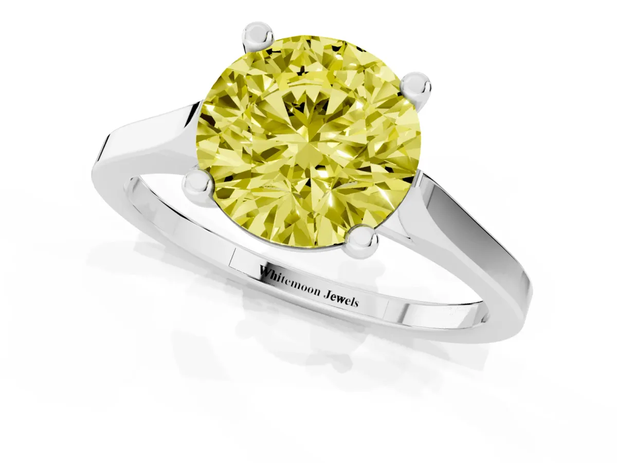 Fancy Yellow Round Cut Solitaire Diamond Ring with Four-Prong Setting and Tapered Band Silver