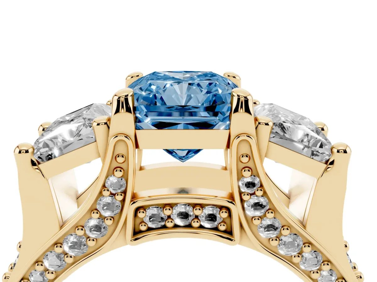 Fancy Blue Radiant Cut Diamond Three-Stone Ring with Channel Set Band and Four-Prong Setting Yellow gold