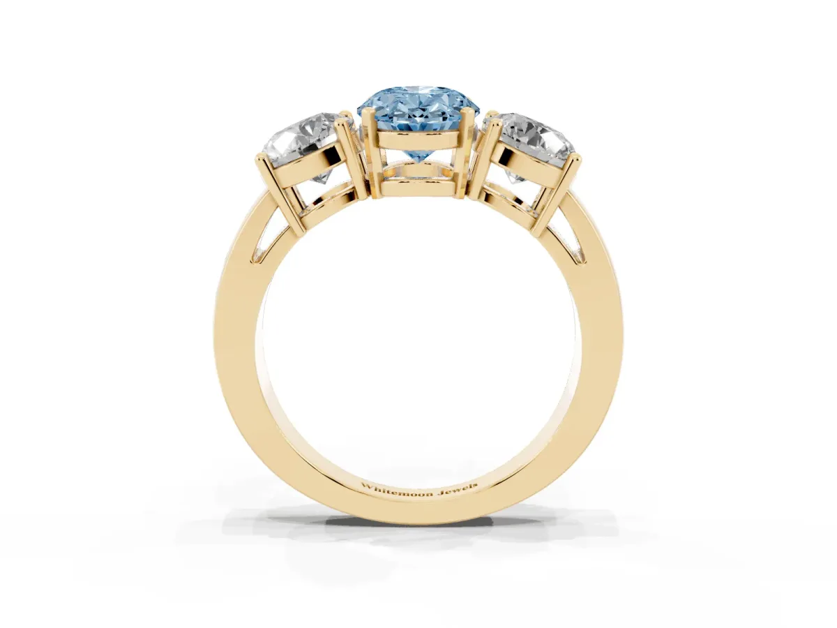 Fancy Blue Three-Stone Oval Cut Diamond Ring with Round Side Stones, Classic Band, and Four-Prong Setting Yellow gold