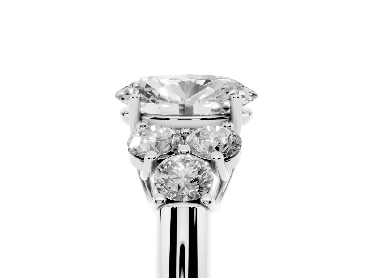 Oval Cut Cut Diamond Cluster Ring with Round Accent Stones and Prong Setting on a Classic Band White gold