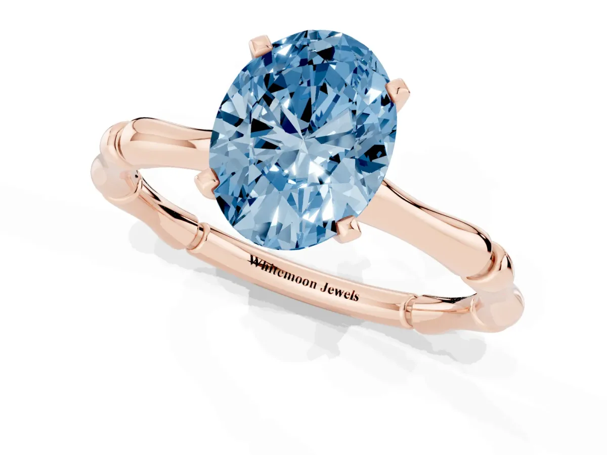Fancy Blue Oval Cut Solitaire Diamond Ring with Bamboo Band and Four-Prong Setting Rose gold
