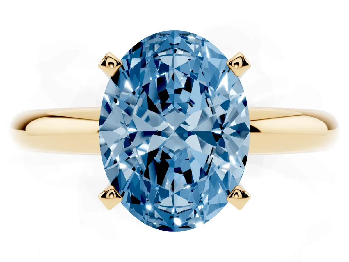 Fancy Blue Oval Cut Diamond Solitaire Engagement Ring with Round Band and Four-Prong Setting Yellow gold