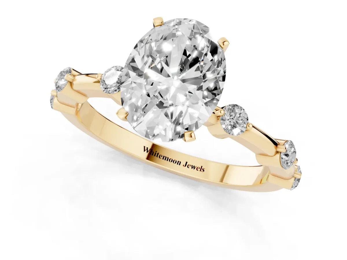 Oval Cut Solitaire Diamond Ring with Bezel Set Side Stones and Prong Setting Yellow gold