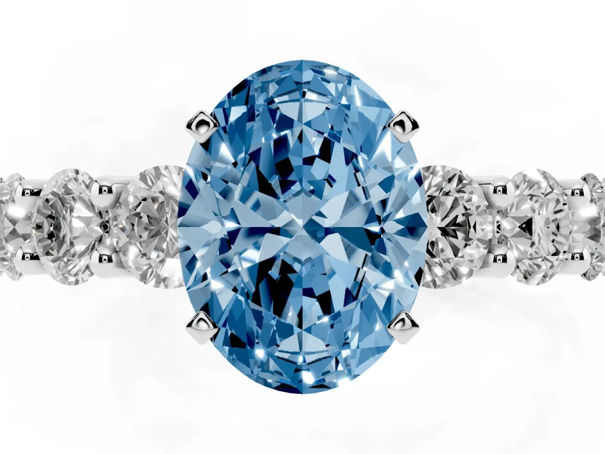 Fancy Blue Oval Cut Diamond Prong Setting with Side Stones on a Pave Band Silver