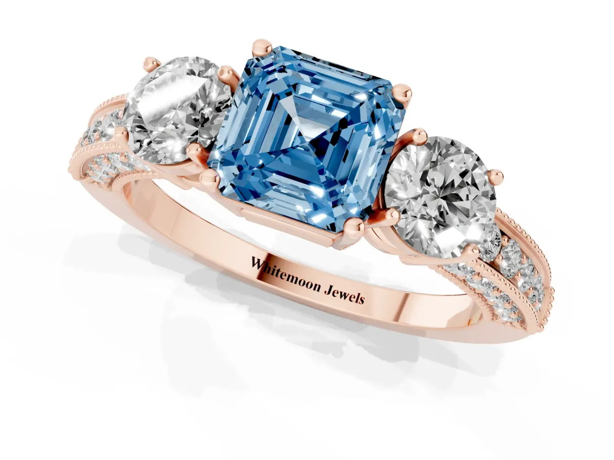 Fancy Blue Asscher Cut Three-Stone Diamond Ring with Pavé Band and Four-Prong Setting Rose gold