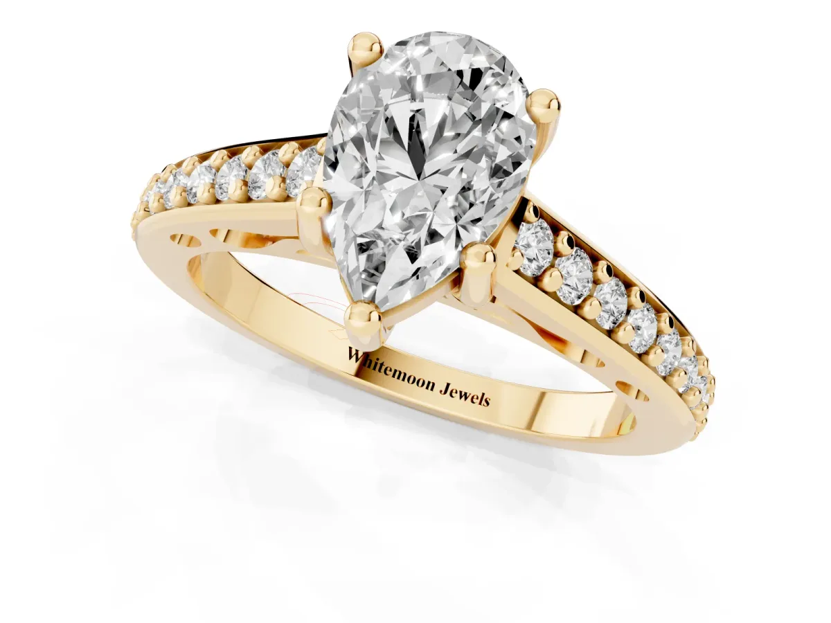 Pear Cut Solitaire Prong Set Diamond Engagement Ring with Pave Band Yellow gold
