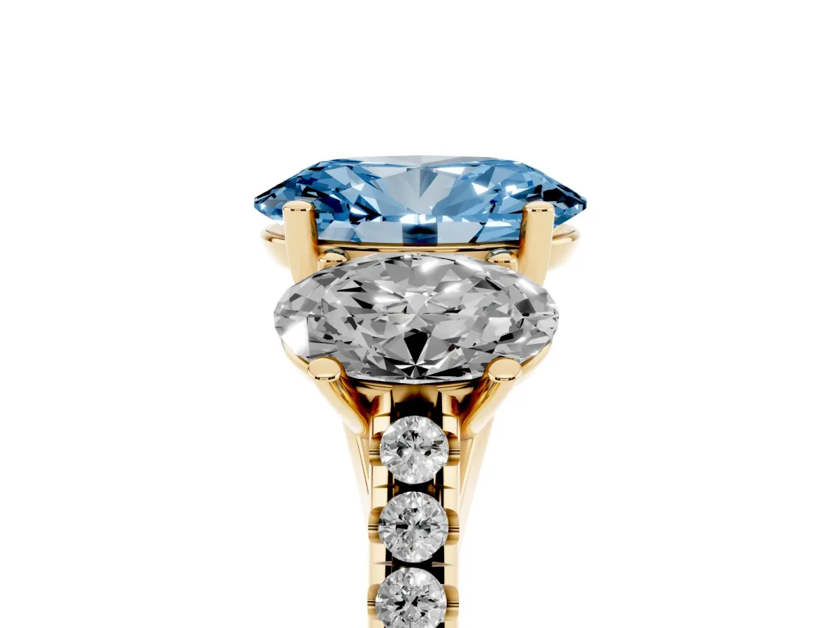 Fancy Blue Three-Stone Oval Cut Diamond Ring with Round Pavé Band and Prong Setting Yellow gold